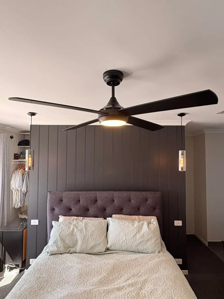 Two large black ceiling fans installed on a vaulted alfresco ceiling
