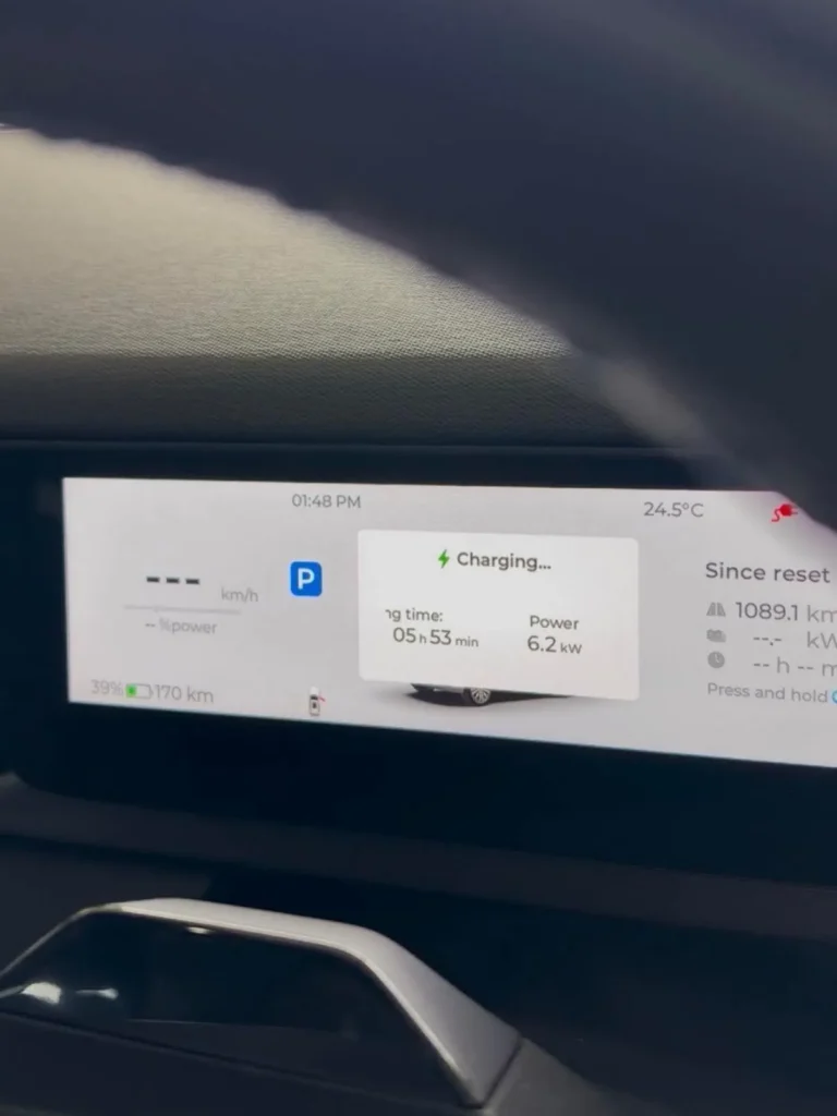 Electric vehicle dashboard reading Charging at 6.2 kW with 5 hours 53 minutes remaining