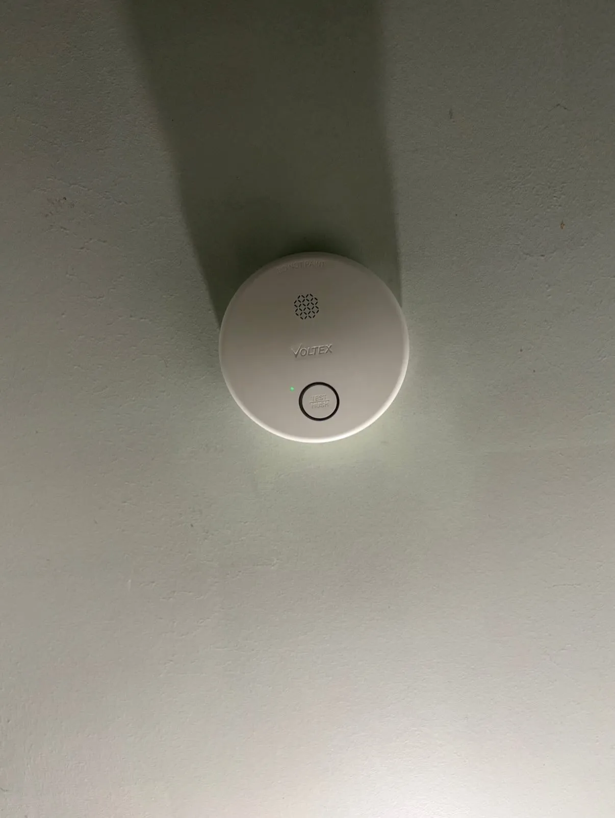 Voltex hardwired photoelectric smoke alarm installed on a ceiling