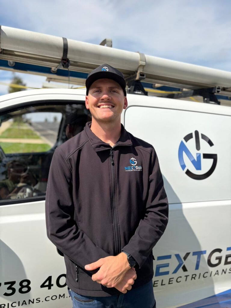 Harley, owner of NextGen Electricians, in front of the company van outside a Bacchus Marsh job