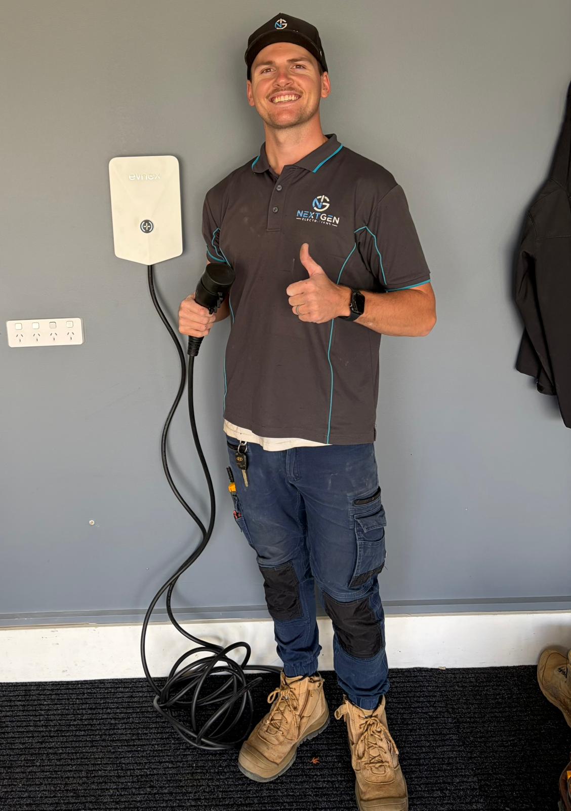 Harley standing next to an EVnex EV charger he installed
