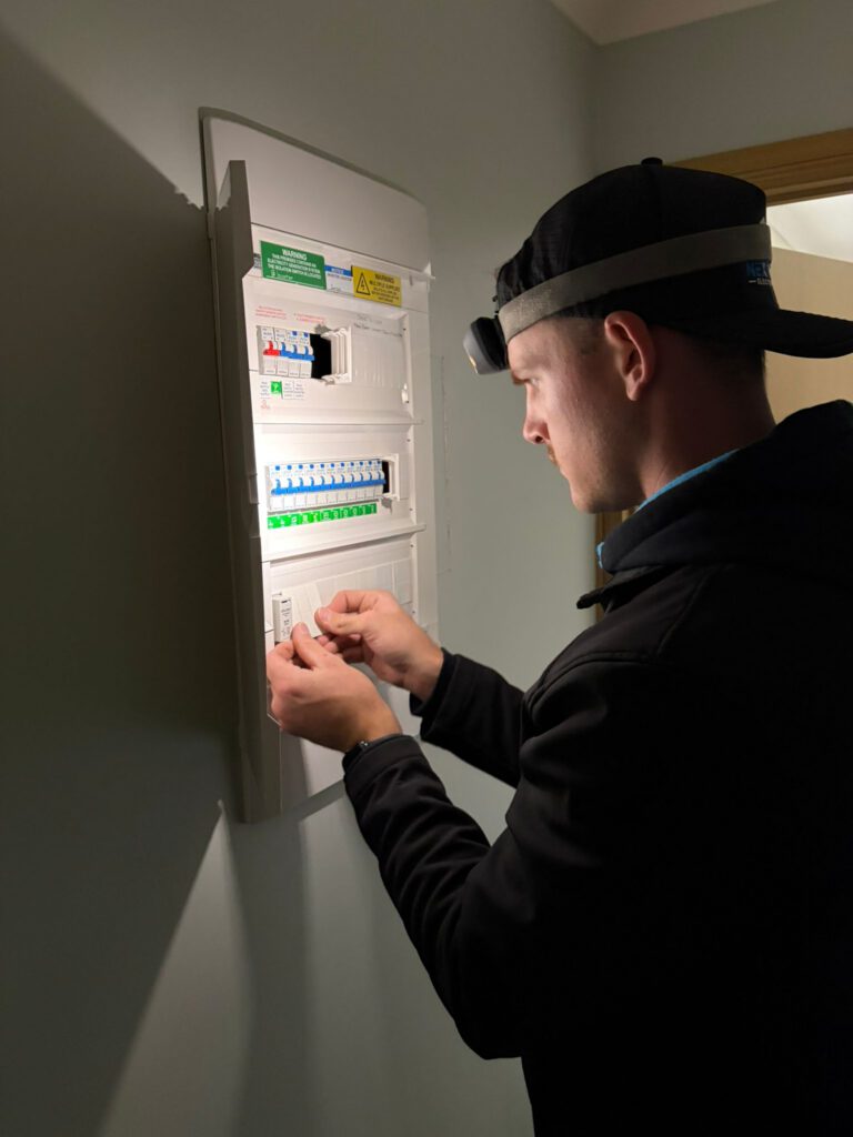 Harley terminating circuits inside a new residential switchboard during an after-dark upgrade