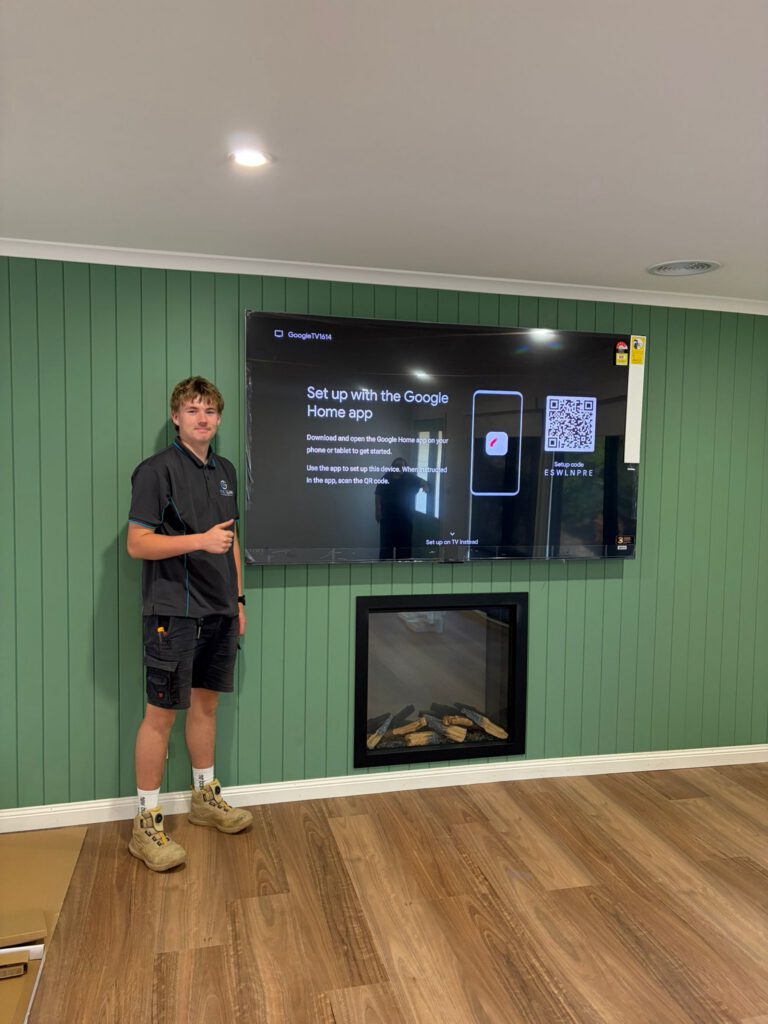 Large TV wall-mounted over a fireplace with cables concealed