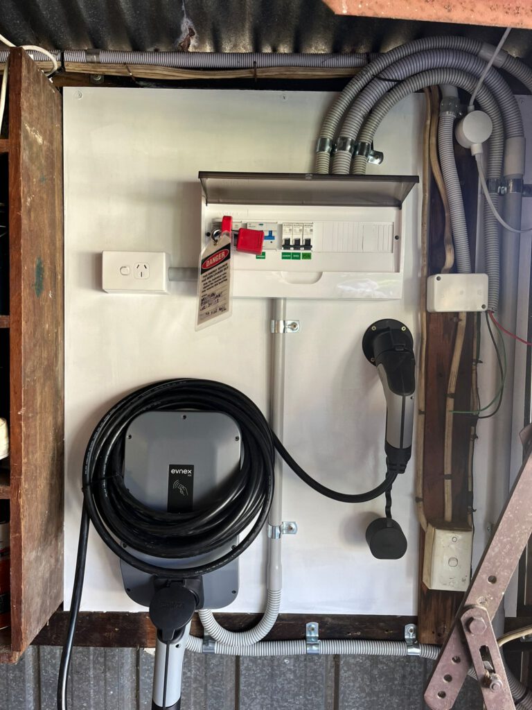 Evnex EV charger installed alongside a garage sub-board with dedicated EV circuit