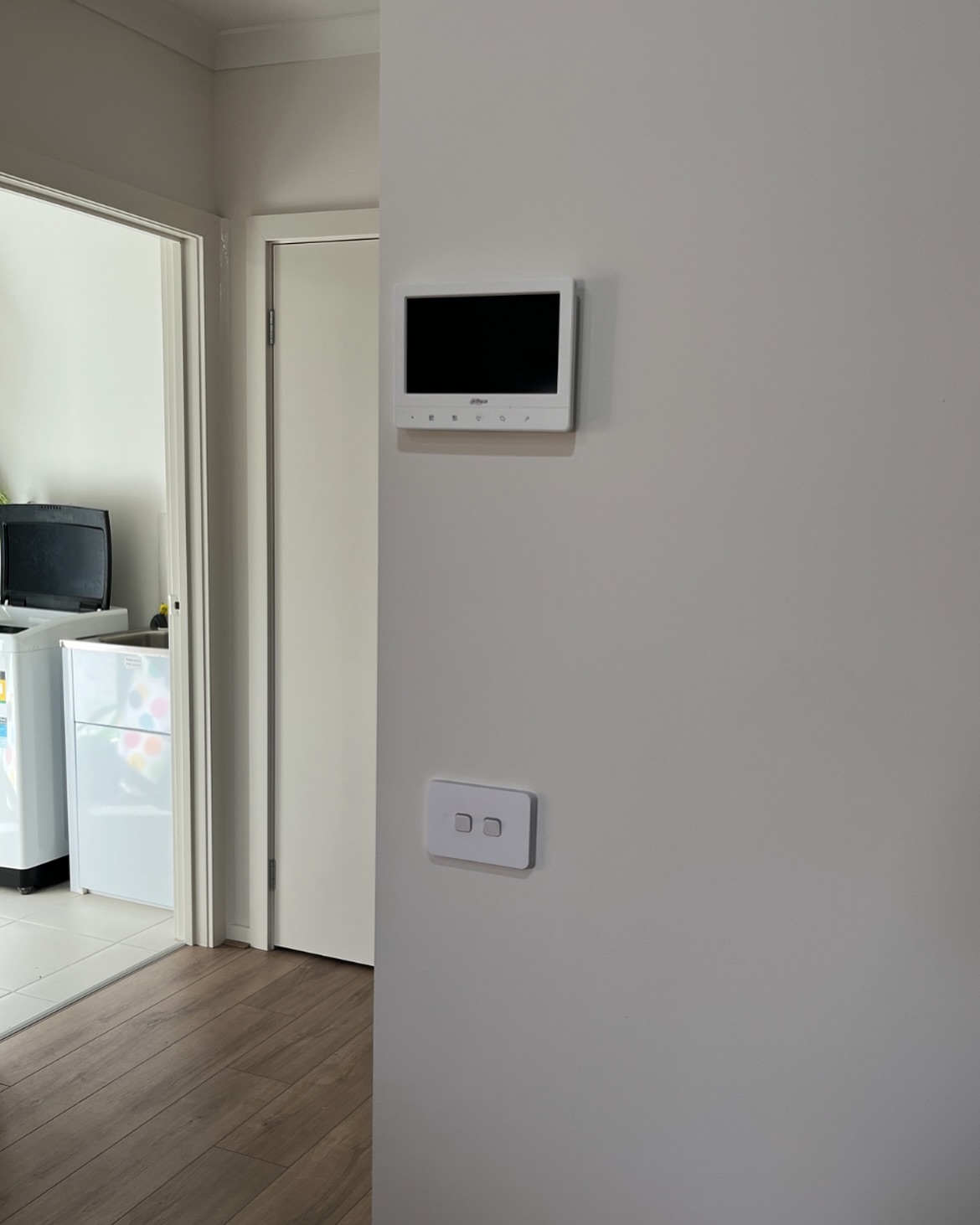 Dahua video intercom monitor installed on a hallway wall