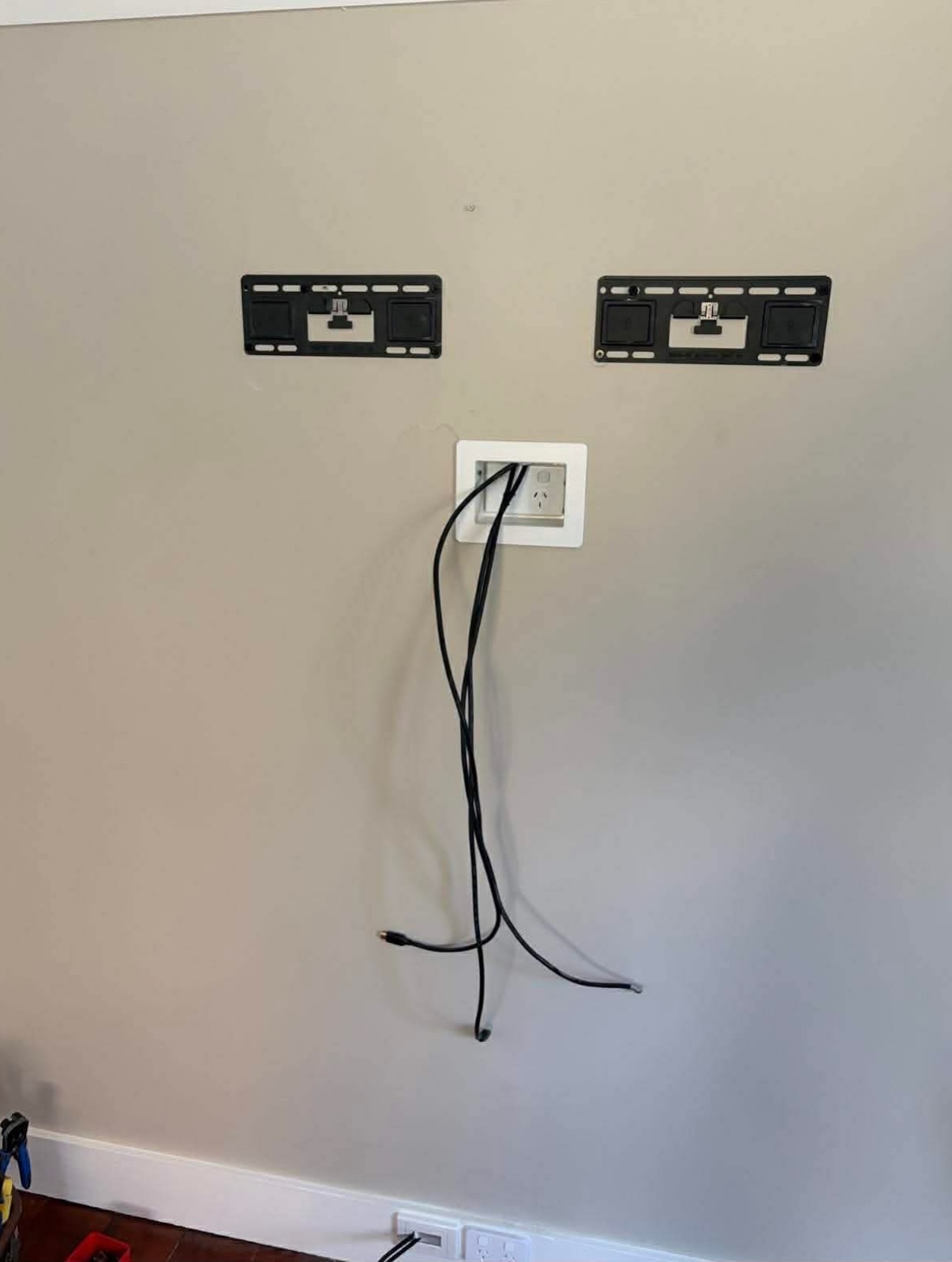 TV wall mount brackets installed with a recessed power and data point ready for a wall mounted television